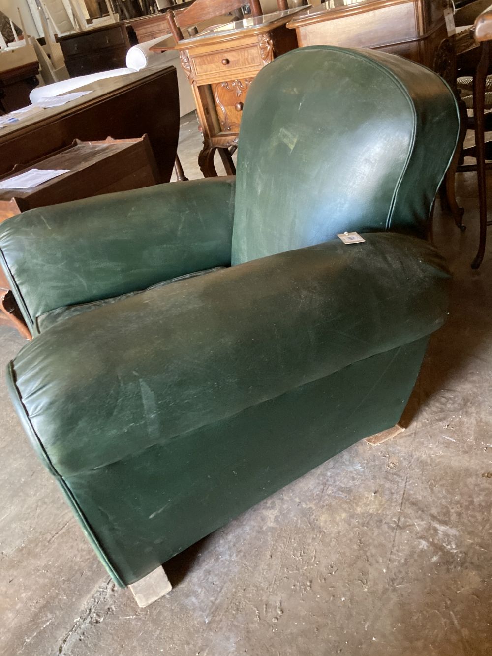 An Art Deco green leatherette armchair